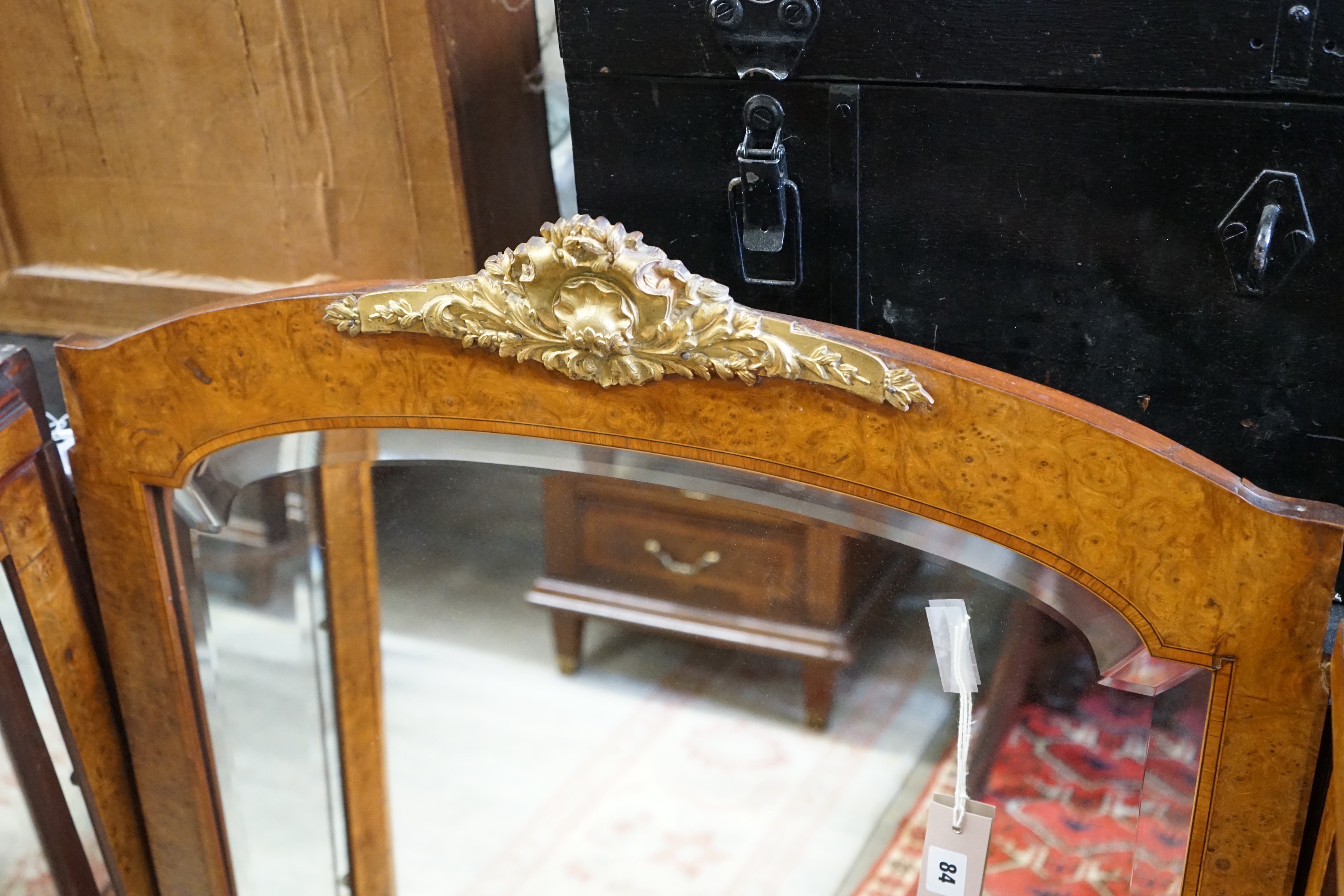 A pair of early 20th French birds eye maple glazed cabinets and central mirror, formerly a cabinet superstructure, total width approximately 156cm